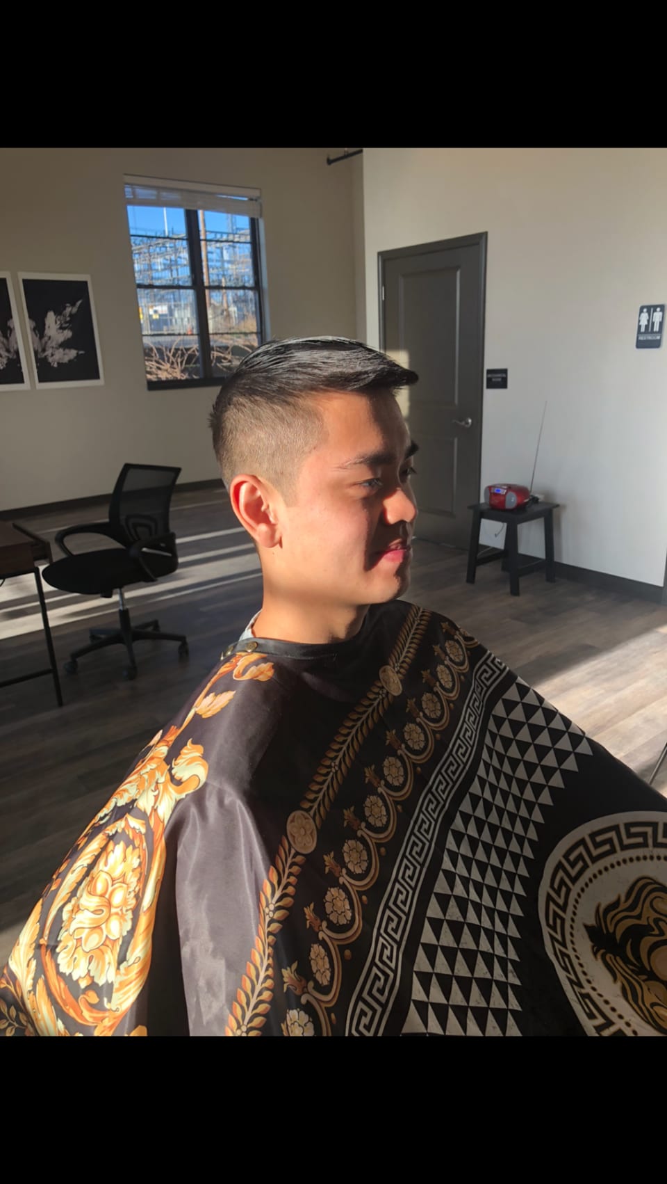 Client seated after a clean taper haircut