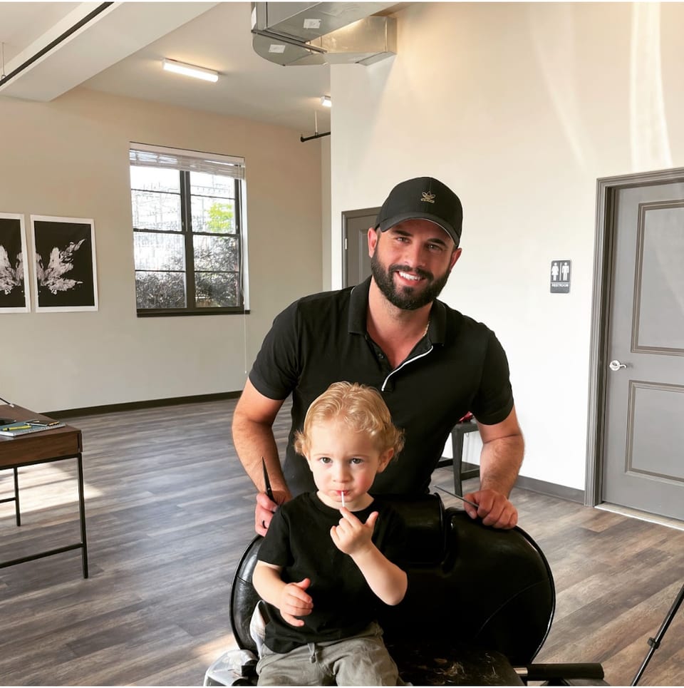 Barber and young client in the shop